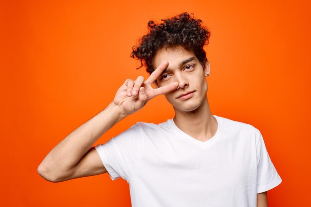 Guy with curly hair gestures with his hand emotions modern style High quality photo