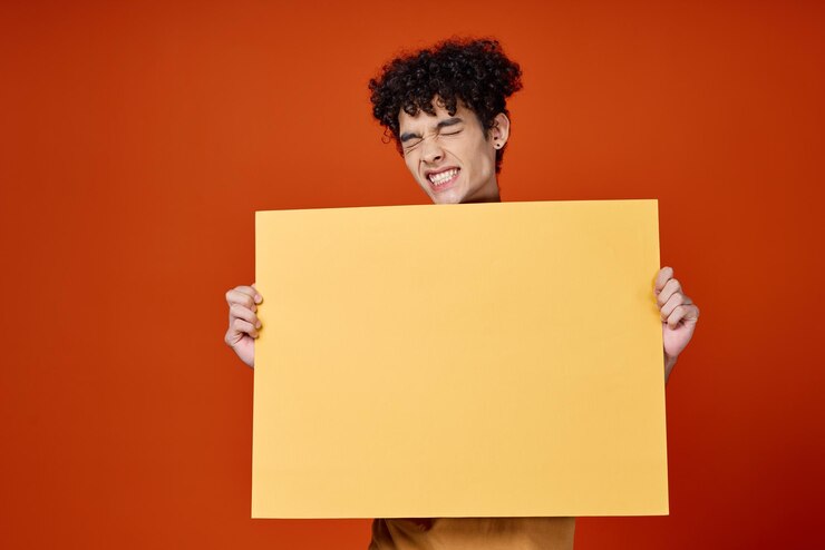 Photo guy with curly hair yellow poster advertising red isolated background