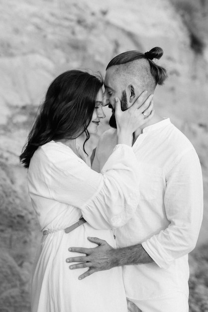 A guy with a girl in white clothes on the seashore