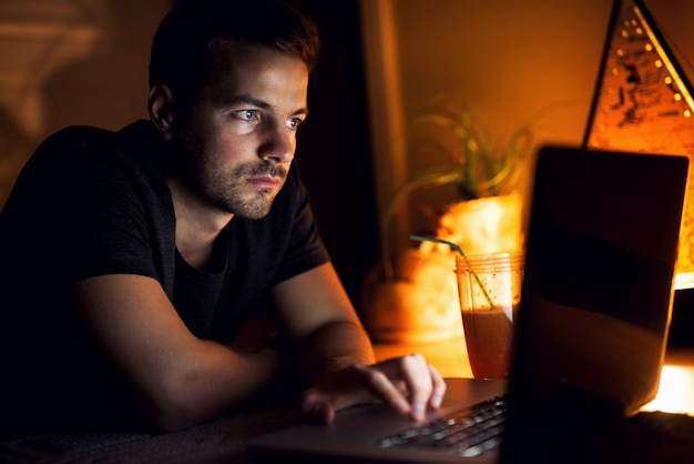 Guy with a laptop. Watching videos and chilling at home