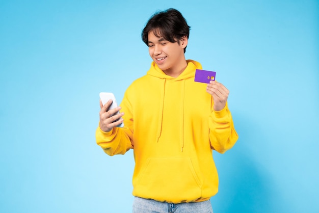 Guy with phone and card online shopping