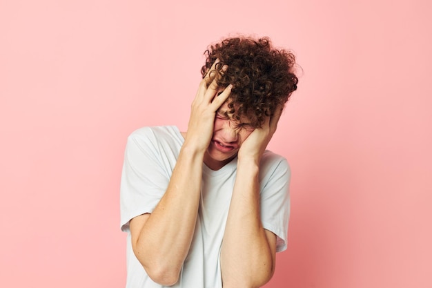 Guy with red curly hair posing youth style white tshirt isolated background unaltered