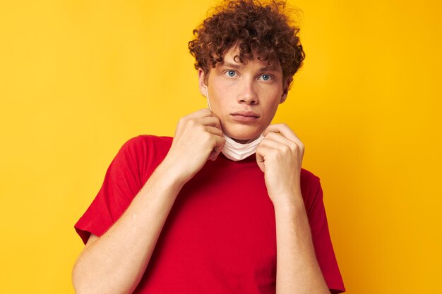 Guy with red curly hair in a red tshirt medical mask protection Lifestyle unaltered