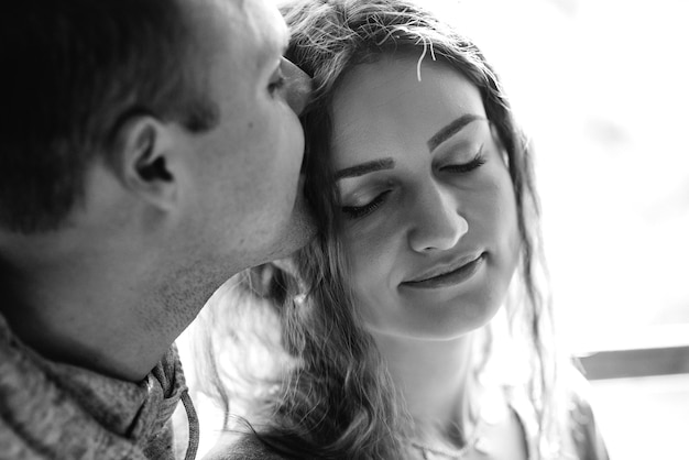 Guy and woman in the house near the window overlooking a snowy landscape