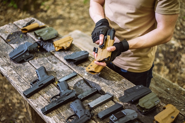 Guy in the woods tests his weapons for shooting sports