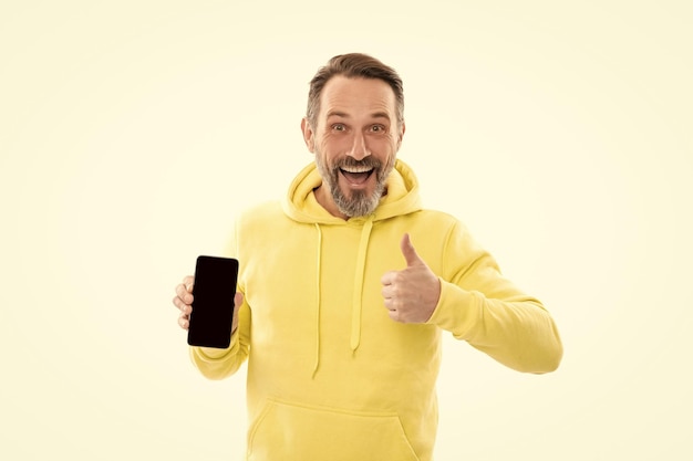 Guy in yellow hoody with thumb up product proposal advertisement presentation copy space