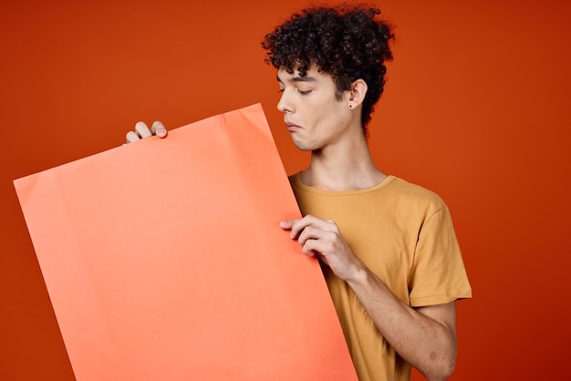 A guy in a yellow tshirt with an island in his hands copy space advertisement high quality photo