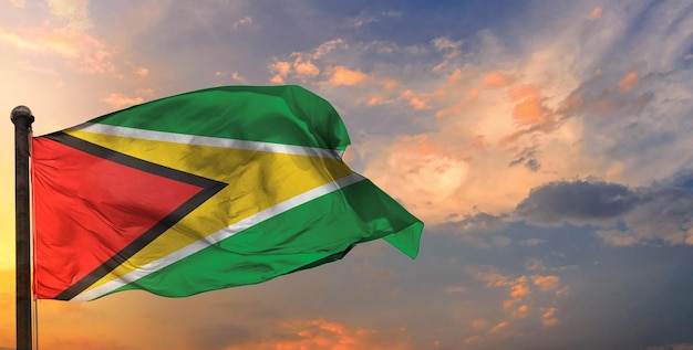 The guyana waving flag and sky background.