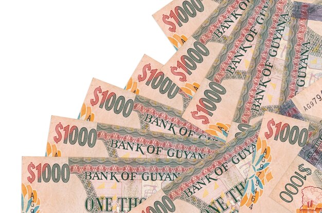 Photo guyanese dollars bills laying in different order on white surface