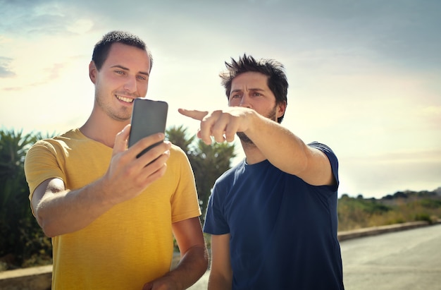 Guys checking a smartphone