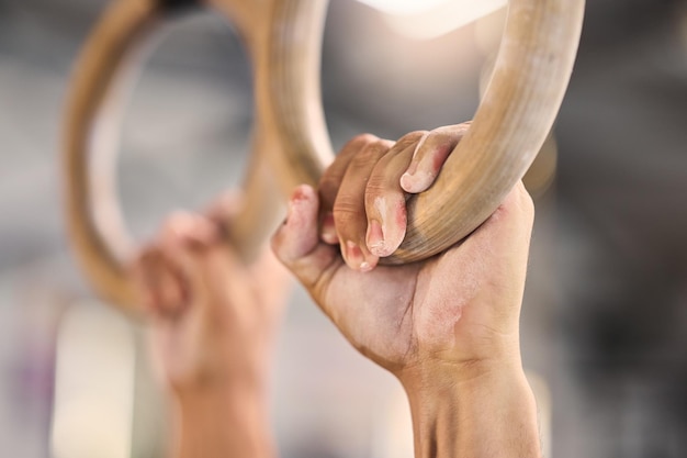 Gym hands and rings workout by man for fitness muscle and training closeup with mockup Hand exercise and gym ring pull up by athlete guy cross energy and endurance challenge performance and fit