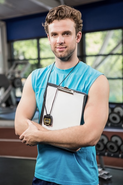 Gym instructor holding clipboard