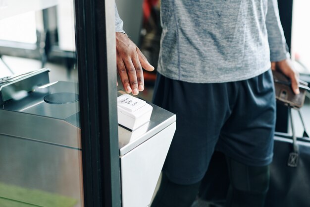 Gym visitor pushing exit button