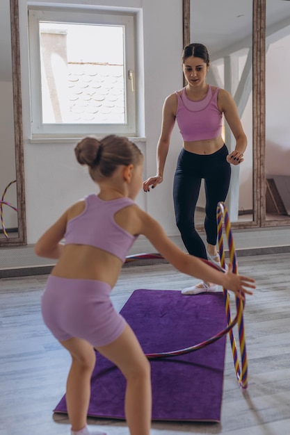 gymnast child performs an exercise with hoopchildrens professional sports