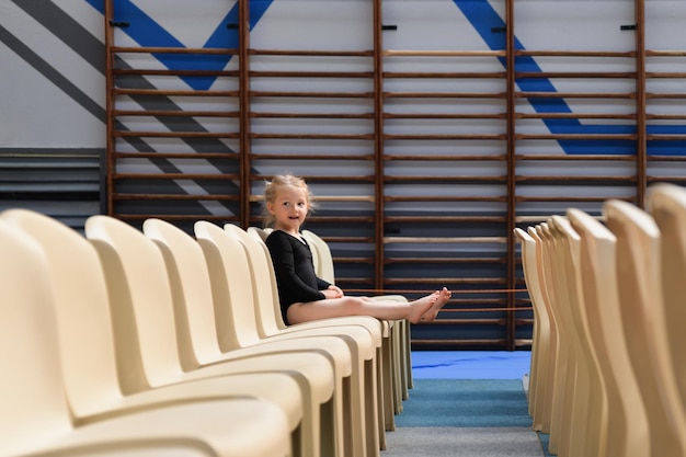 A gymnast girl sitting in the auditorium