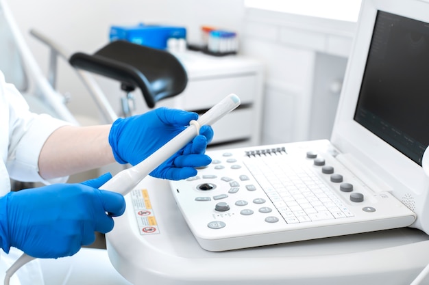 Gynecologist doctor prepares an ultrasound machine for the diagnosis of patient