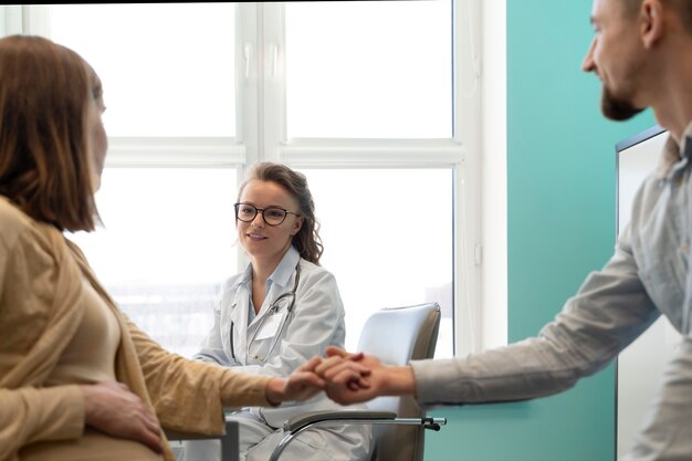 Gynecologist evaluating pregnancy with patient