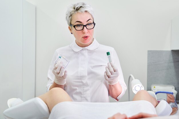 Gynecologist holding empty plasmolifting device before using it