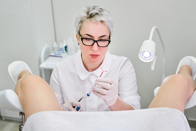 Gynecologist holding an IUD birth control device before using it for patient