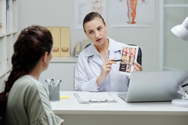 Gynecologist talking to patient at office