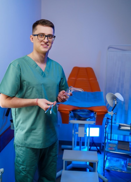 Gynecologist with vaginal speculum in clinic before patient examination