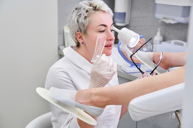 Gynecologist with vaginal speculum in clinic before patient examination