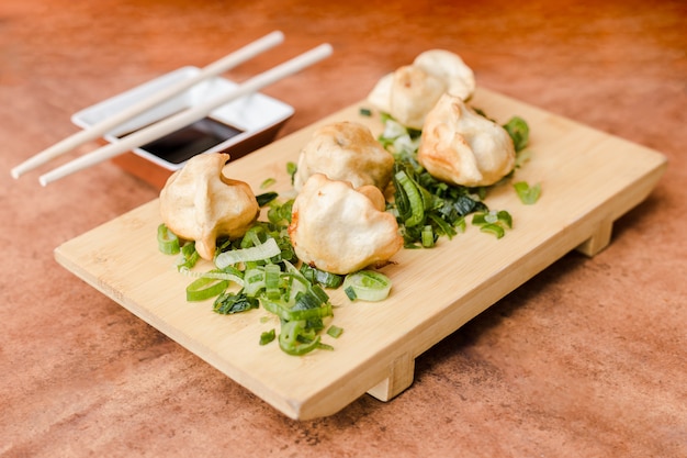 Gyoza with soy sauce on a wooden table