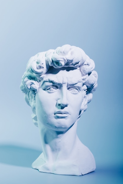 Gypsum copy of the sculpture David Michelangelo on blue background