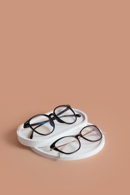 Gypsum elements with eyeglasses on colored background Optical store vision test stylish glasses concept top view flat lay