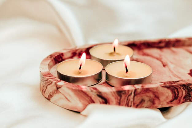 Gypsum marble decorative stand with candles on the background of silk stand