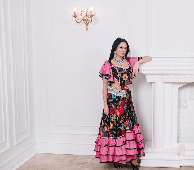 Gypsy woman standing near the fireplace. photo with copy space