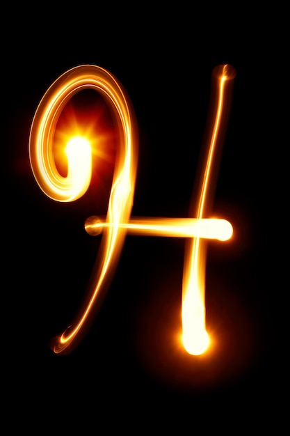 H - Created by light alphabet over black background