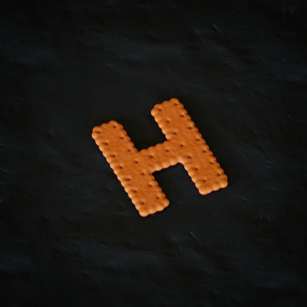 h letter 3d rendered realistic cookie on black background character