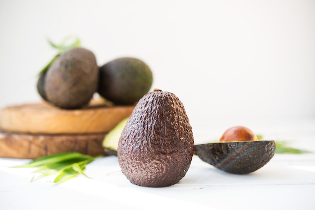 Haas avocado on a wooden board, natural products, selective focus