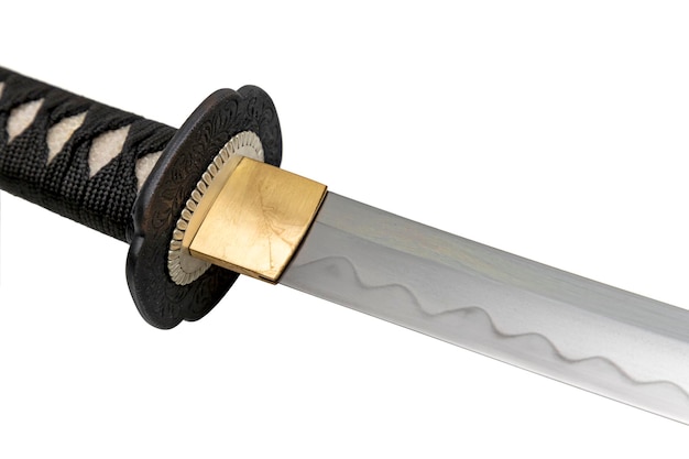 The Habaki collar is made of polished brass It is at the base of a Japanese sword blade with a wavy pattern on the sharp part isolated on a white background Selective focus