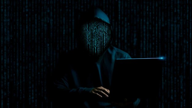 hacker face made with binary code anonymous computer hacker cyber attack hacker using the laptop