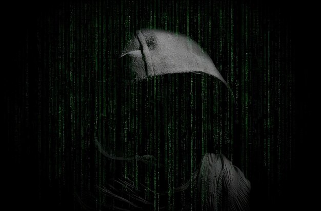 Hacker in hood with binary code on dark background cyber security concept