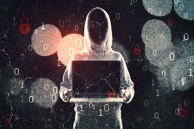 Photo hacker in hoodie showing laptop while standing on abstract dark hacking background with bokeh circles and binary coding malware and phishing data theft concept