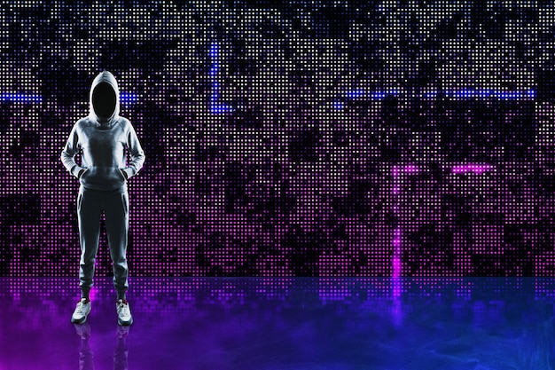 Hacker in hoodie standing on abstract glowing pixel wall background Large led projection screens and data hacking concept