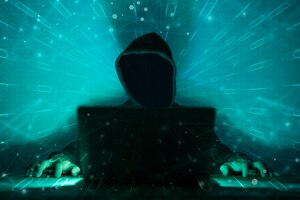 hacker in front of his computer dark face