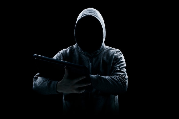 hacker prints a code on a laptop keyboard to break into a cyberspace