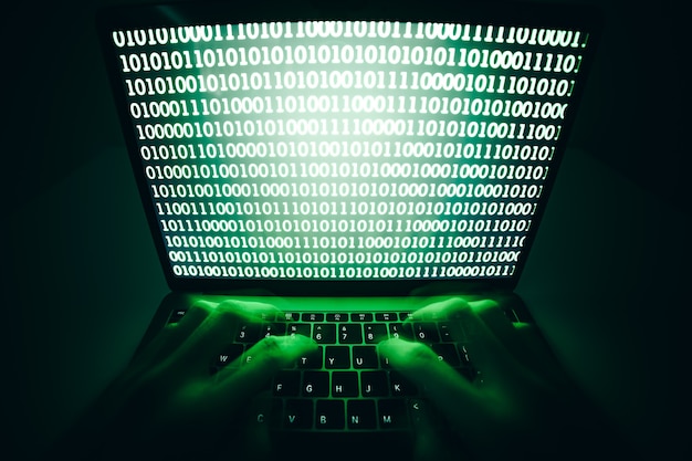 hacker using laptop to coding virus or malware for hacking internet server Cyber attack