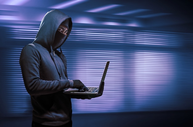 Hacker using laptop. Hacking the Internet.