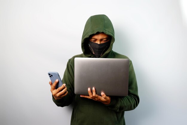 Hacker using laptop to steal personal data from people and calling someone to request a ransom isolated on white background