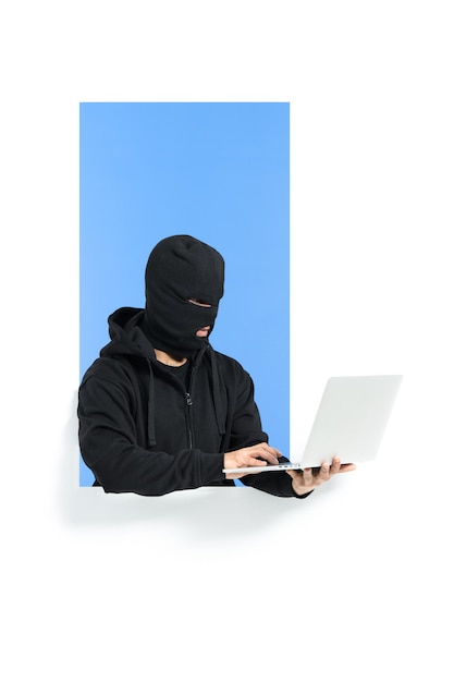 hacker wearing a mask stealing money from bank account using a computer. internet security concept.