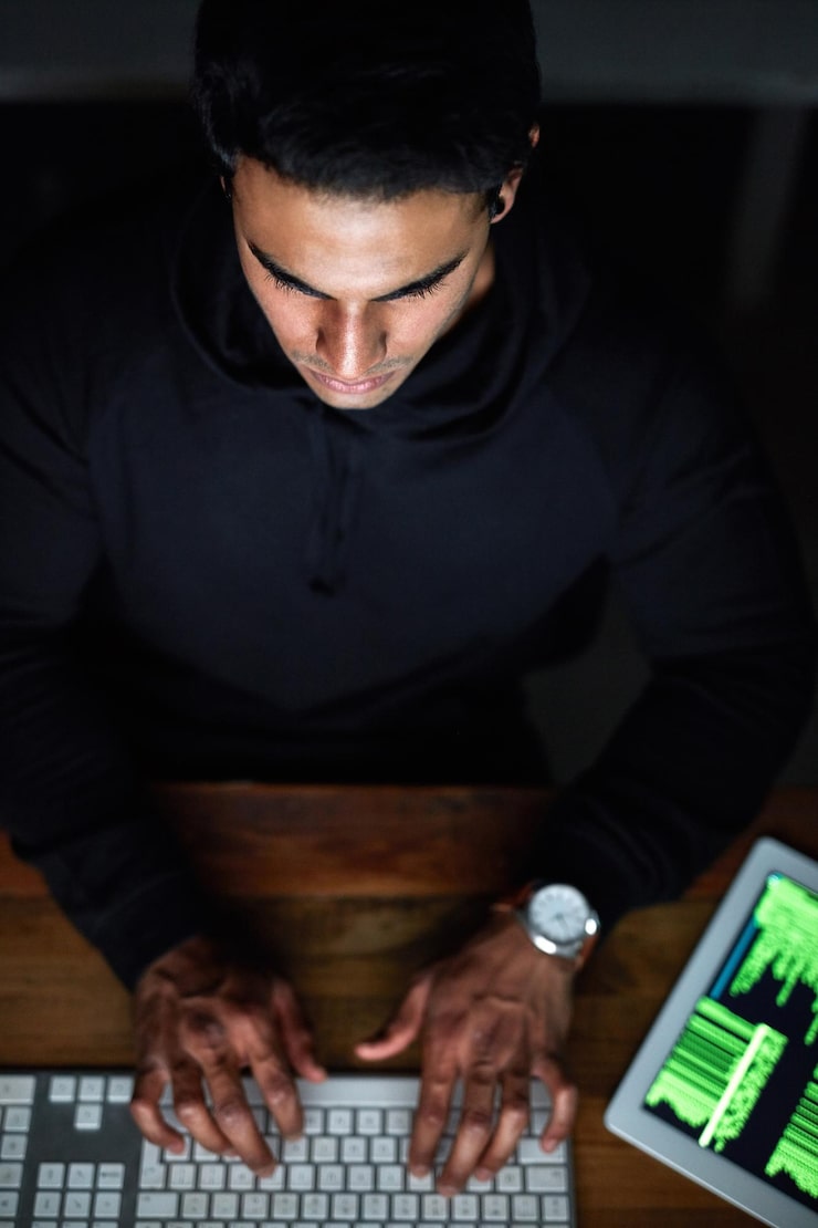 Photo hacking man and computer keyboard for programming coding software or password hacker tablet and dark room online code night cyber security or programmer person hacking data on digital tech above