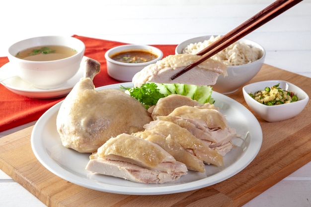 Hainanese chicken rice , Steamed chicken with rice, Khao Mun Kai on wood background