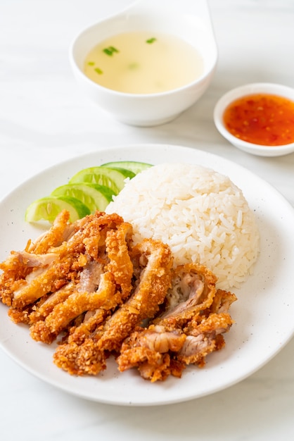 Hainanese chicken rice with fried chicken or rice steamed chicken soup with fried chicken - Asian food style