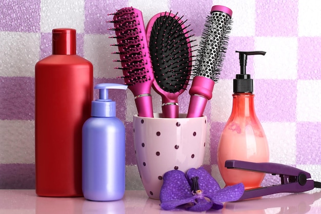 Photo hair brushes and cosmetic bottles in bathroom