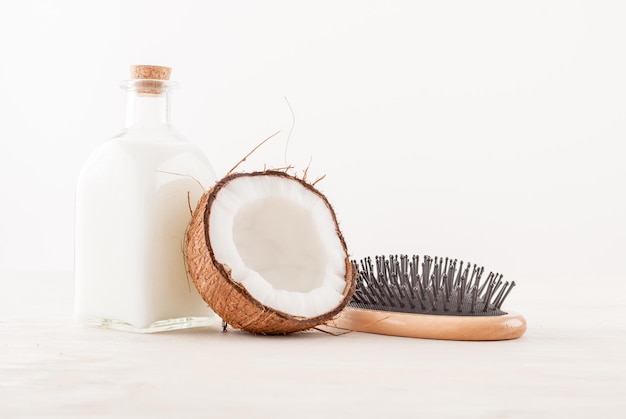 hair care concept with coconut oil on white background